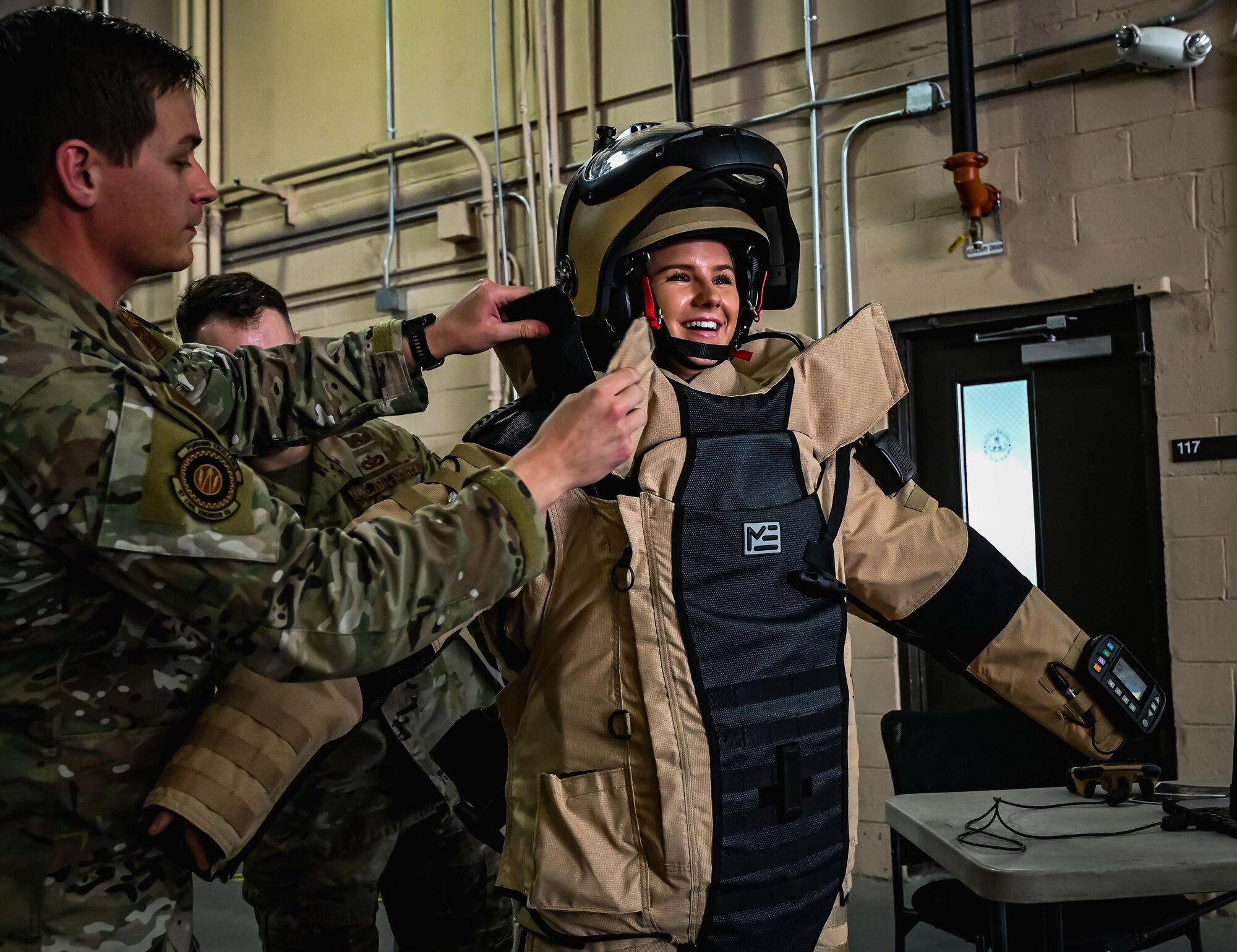 Formula Drift driver Amanda Sorenson puts on a bomb disposal suit at Joint Base McGuire-Dix-Lakehurst on June 7, 2022. Drift team duo Branden and Amanda Sorensen visited JB MDL to interact with Airmen and learn about different Air Force career fields. Air Force Recruiting Service recently continued their 13-year partnership with the Formula Drift series. Throughout the 2022 Formula Drift circuit, the Air Force will serve as the primary sponsor for the Sorensen Motorsports team.