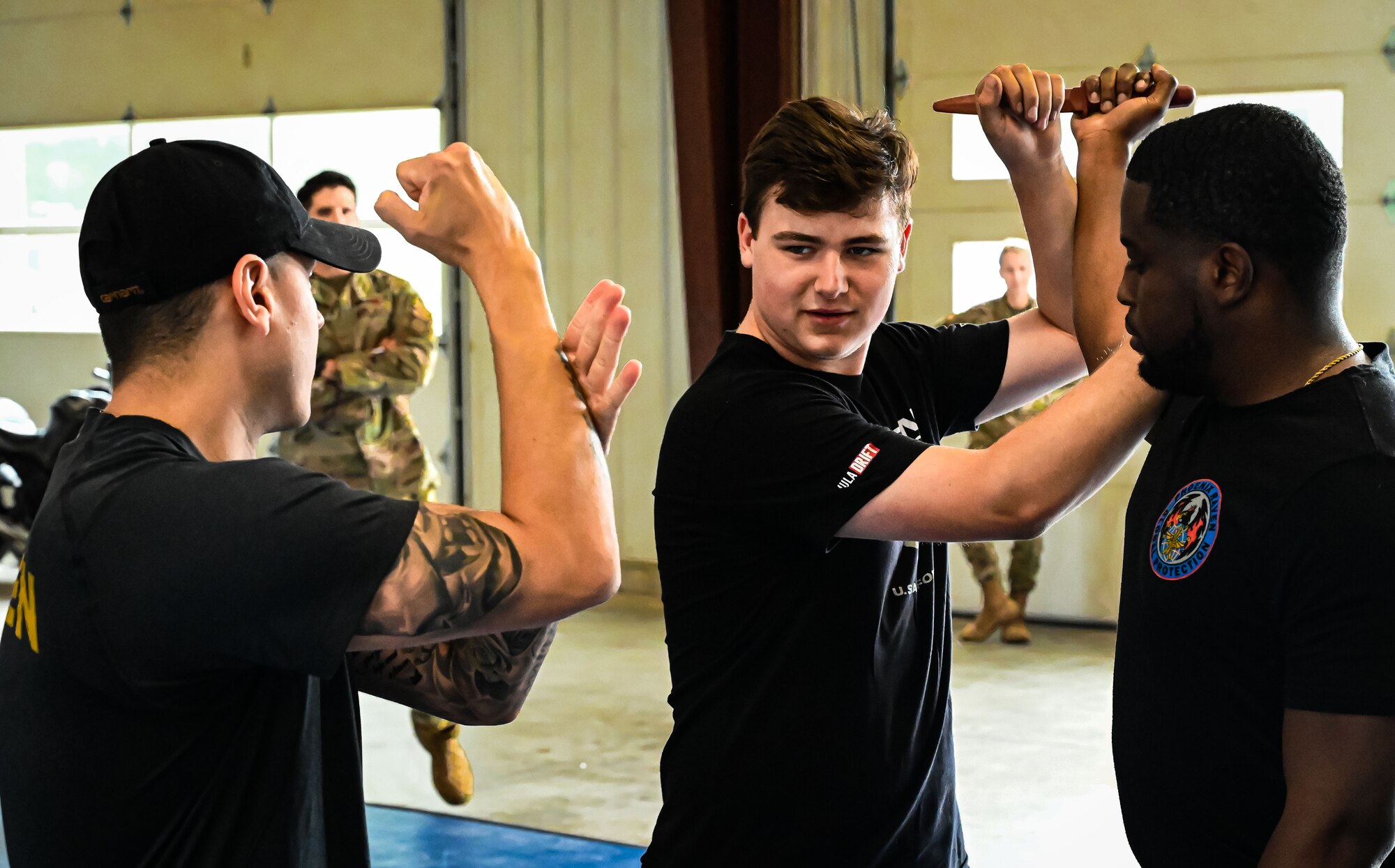 U.S. Air Force Staff Sergeant Jonathan Cardona, Raven Team Member with the 87th Security Forces Squadron, teaches disarming combatant techniques to Formula Drift driver Branden Sorenson at Joint Base McGuire-Dix-Lakehurst on June 7, 2022. Drift team duo Branden and Amanda Sorensen visited JB MDL to interact with Airmen and learn about different Air Force career fields. Air Force Recruiting Service recently continued their 13-year partnership with the Formula Drift series. Throughout the 2022 Formula Drift circuit, the Air Force will serve as the primary sponsor for the Sorensen Motorsports team.