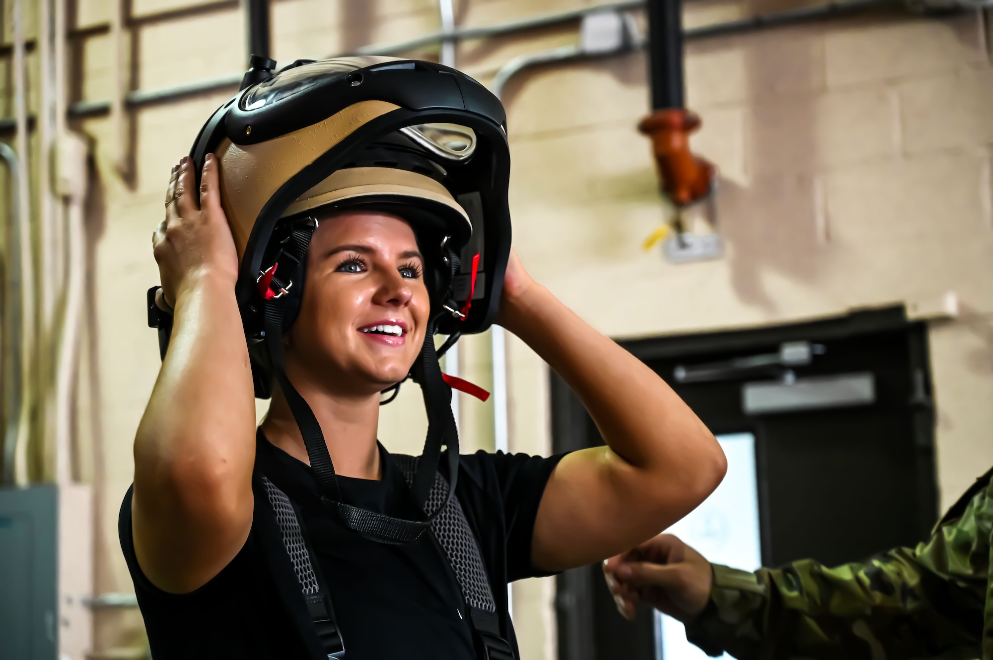 Formula Drift driver Amanda Sorenson puts on a bomb disposal suit helmet during a demo at Joint Base McGuire-Dix-Lakehurst on June 7, 2022. Drift team duo Branden and Amanda Sorensen visited JB MDL to interact with Airmen and learn about different Air Force career fields. Air Force Recruiting Service recently continued their 13-year partnership with the Formula Drift series. Throughout the 2022 Formula Drift circuit, the Air Force will serve as the primary sponsor for the Sorensen Motorsports team.