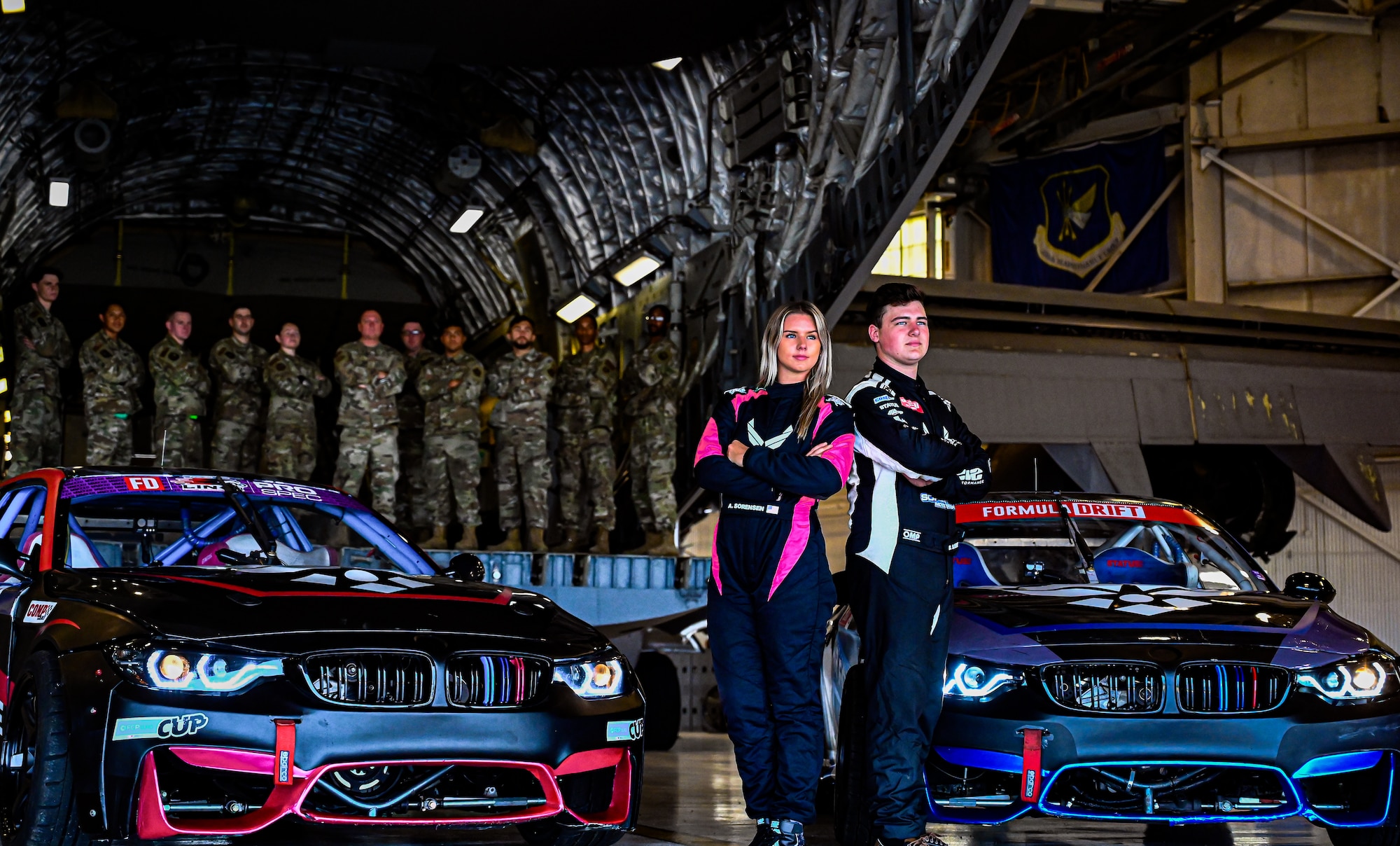Formula Drift drivers Branden and Amanda Sorenson pose with Airmen from the 305th Air Mobility Wing at Joint Base McGuire-Dix-Lakehurst on June 7, 2022. Drift team duo Branden and Amanda Sorensen visited JB MDL to interact with Airmen and learn about different Air Force career fields. Air Force Recruiting Service recently continued their 13-year partnership with the Formula Drift series. Throughout the 2022 Formula Drift circuit, the Air Force will serve as the primary sponsor for the Sorensen Motorsports team.