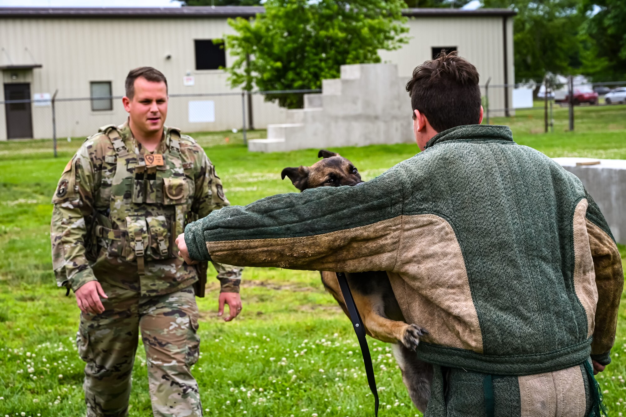 U.S. Air Force Staff Sergeant Timothy Perry commands his military working dog Erica, 87th Security Forces Squadron, to bite Formula Drift driver Branden Sorenson during a demo at Joint Base McGuire-Dix-Lakehurst on June 7, 2022. Drift team duo Branden and Amanda Sorensen visited JB MDL to interact with Airmen and learn about different Air Force career fields. Air Force Recruiting Service recently continued their 13-year partnership with the Formula Drift series. Throughout the 2022 Formula Drift circuit, the Air Force will serve as the primary sponsor for the Sorensen Motorsports team.