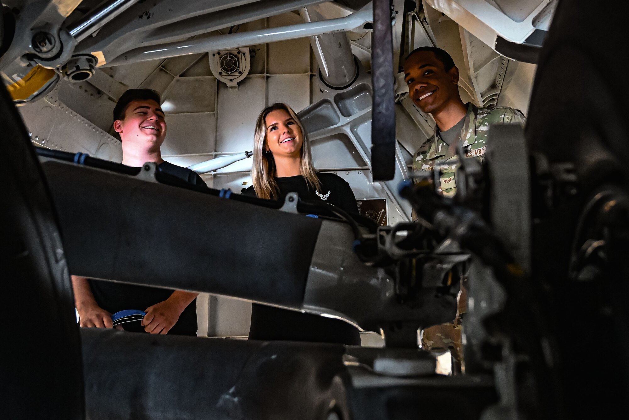 U.S. Air Force Airman First Class Gabriel Johnson, 305th Aircraft Maintenance Squadron, guides Formula Drift drivers Amanda and Branden Sorensen through the wheel well of a C-17 Globemaster III aircraft during a tour at Joint Base McGuire-Dix-Lakehurst on June 7, 2022. Drift team duo Branden and Amanda Sorensen visited JB MDL to interact with Airmen and learn about different Air Force career fields. Air Force Recruiting Service recently continued their 13-year partnership with the Formula Drift series. Throughout the 2022 Formula Drift circuit, the Air Force will serve as the primary sponsor for the Sorensen Motorsports team.