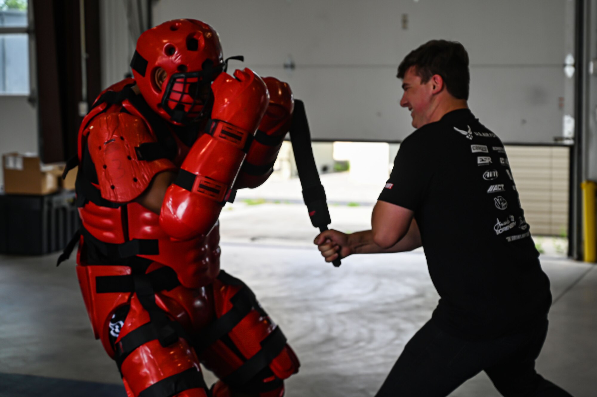 A U.S. Air Force Raven Team Member, 87th Security Forces Squadron, practices combatives with Formula Drift driver Branden Sorenson during a demo at Joint Base McGuire-Dix-Lakehurst on June 7, 2022. Drift team duo Branden and Amanda Sorensen visited JB MDL to interact with Airmen and learn about different Air Force career fields. Air Force Recruiting Service recently continued their 13-year partnership with the Formula Drift series. Throughout the 2022 Formula Drift circuit, the Air Force will serve as the primary sponsor for the Sorensen Motorsports team.