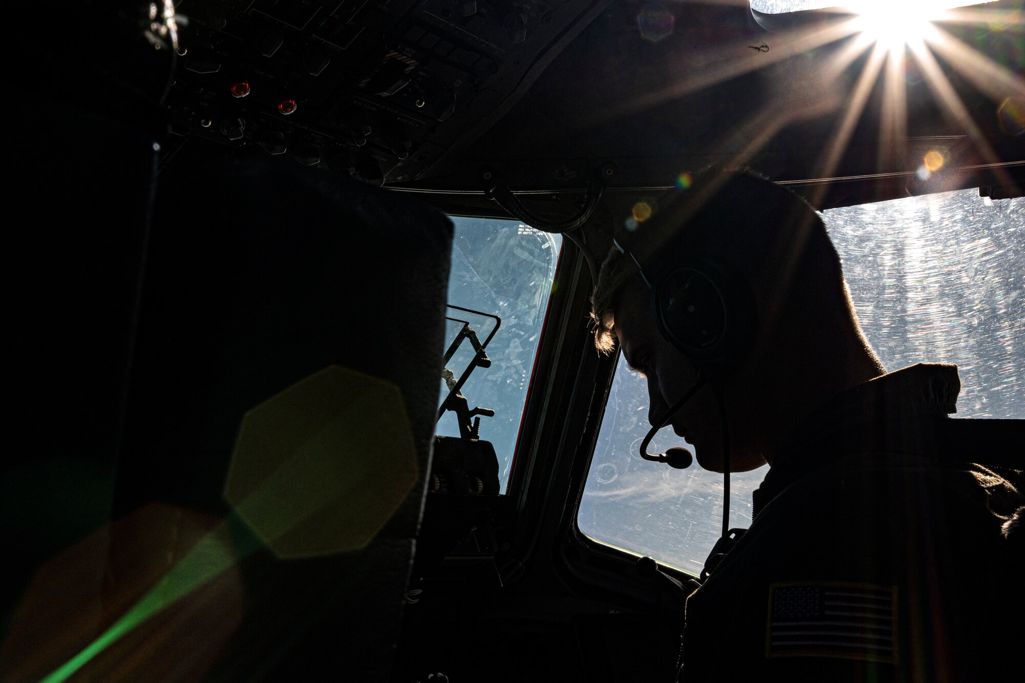 A U.S. Air Force C-17 Globemaster III pilot from Joint Base Elmendorf-Richardson, Alaska, flies with U.S. Army Paratrooper on June 15, 2022 during RED FLAG-Alaska 22-2. Approximately 1,600 service members from three nations participate in flying, maintaining and supporting more than 70 aircraft from over 22 units during this iteration of exercise.  The C-17 Globemaster III is assigned to the 517th Airlift Squadron, JBER. (U.S. Air Force photo by Sheila deVera)