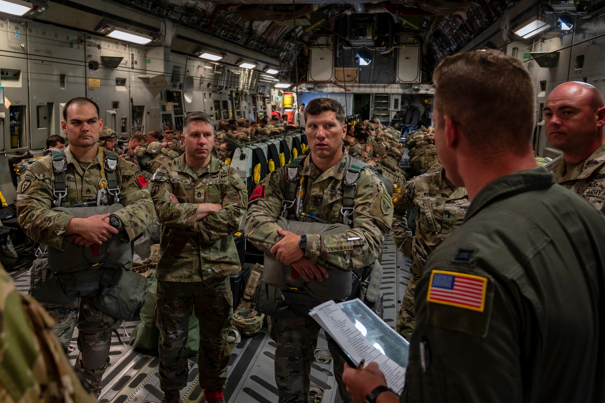 U.S. Air Force C-17 Globemaster III crew from the 517th Airlift Squadron and U.S. Army Paratroopers from the 2nd Infantry Brigade Combat Team (Airborne), 11th Airborne Division, conduct a preflight brief prior to a static line jump at Allen Army Airfield, Fort Greely, Alaska, June 15, 2022 during RED FLAG-Alaska 2202. Approximately 1,600 service members from three nations participate in flying, maintaining and supporting more than 70 aircraft from over 22 units during this iteration of exercise. (U.S. Air Force photo by Sheila deVera)
