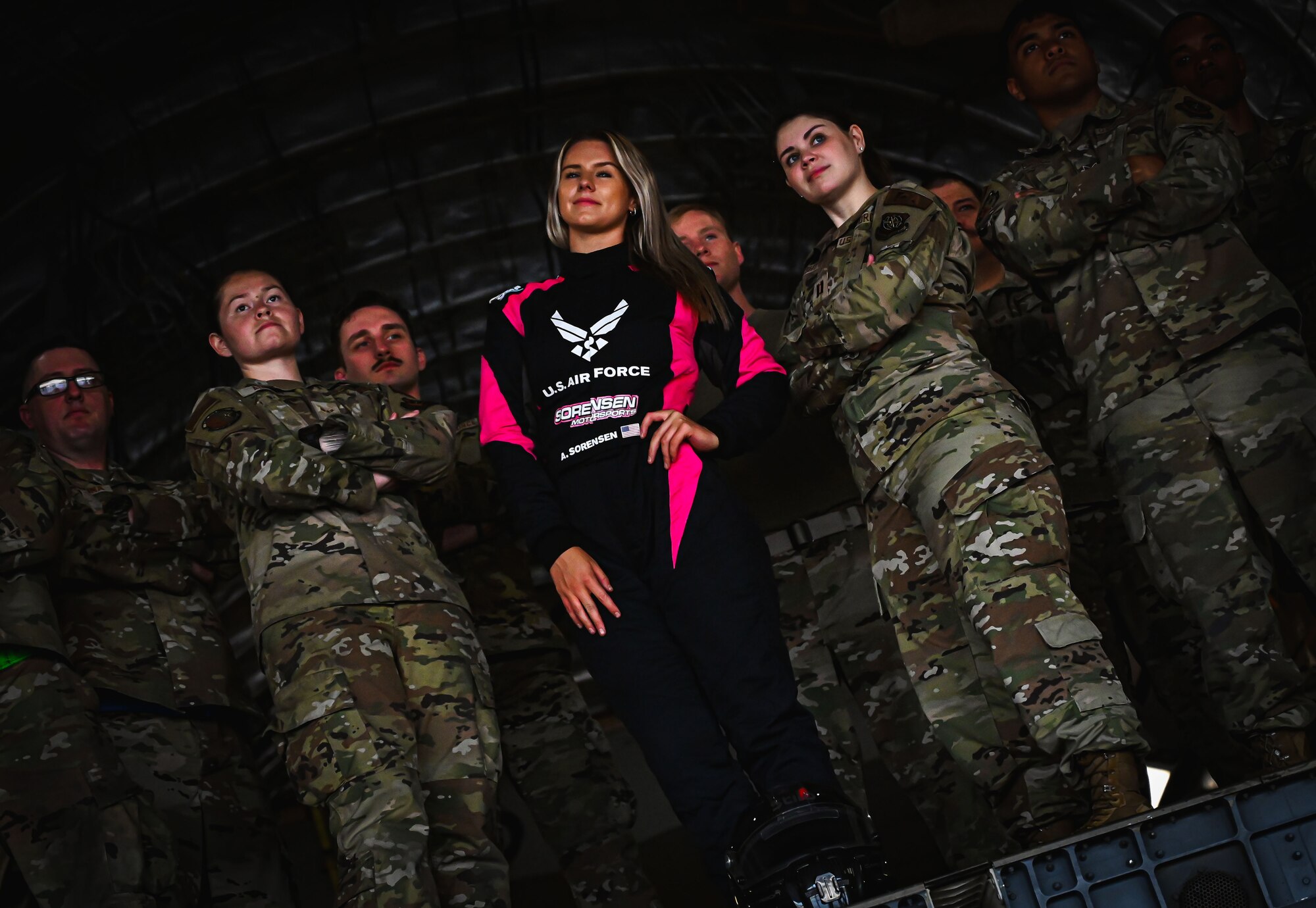 Formula Drift driver Amanda Sorenson poses for a group photo with Airmen from the 305th Air Mobility Wing at Joint Base McGuire-Dix-Lakehurst on June 7, 2022. Drift team duo Branden and Amanda Sorensen visited JB MDL to interact with Airmen and learn about different Air Force career fields. Air Force Recruiting Service recently continued their 13-year partnership with the Formula Drift series. Throughout the 2022 Formula Drift circuit, the Air Force will serve as the primary sponsor for the Sorensen Motorsports team.