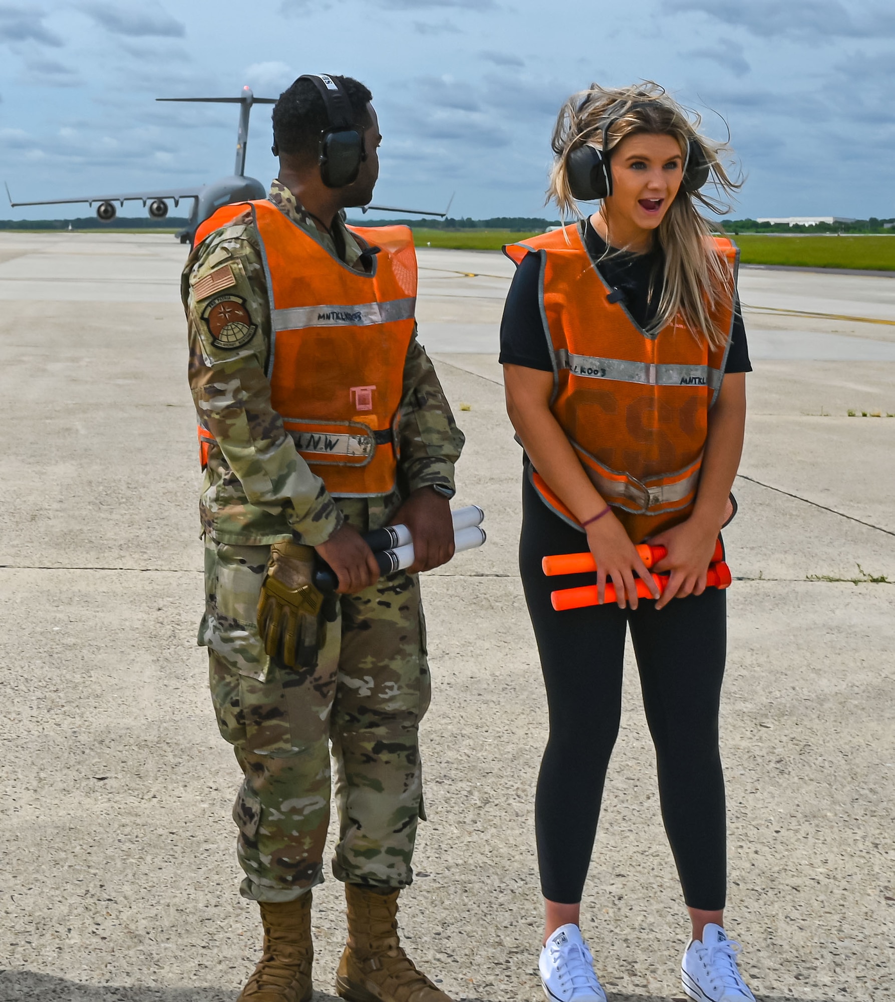 Formula Drift driver Amanda Sorenson expresses her excitement upon feeling the jet blast of a C-17 Globemaster III during a marshaling demo at Joint Base McGuire-Dix-Lakehurst on June 7, 2022. Drift team duo Branden and Amanda Sorensen visited JB MDL to interact with Airmen and learn about different Air Force career fields. Air Force Recruiting Service recently continued their 13-year partnership with the Formula Drift series. Throughout the 2022 Formula Drift circuit, the Air Force will serve as the primary sponsor for the Sorensen Motorsports team.