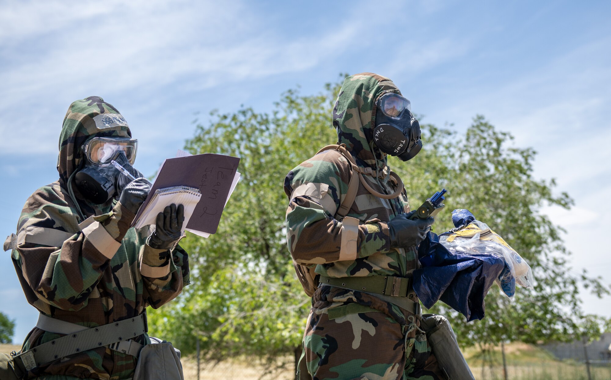 U.S. Air Force Senior Airman Codie Braegger, 419th Civil Engineer Squadron, and Staff Sgt. Eva Escape, 446th Civil Engineer Squadron, approach a simulated gas contamination site during the Patriot Warrior exercise at Hill Air Force Base, Utah, June 11, 2022.