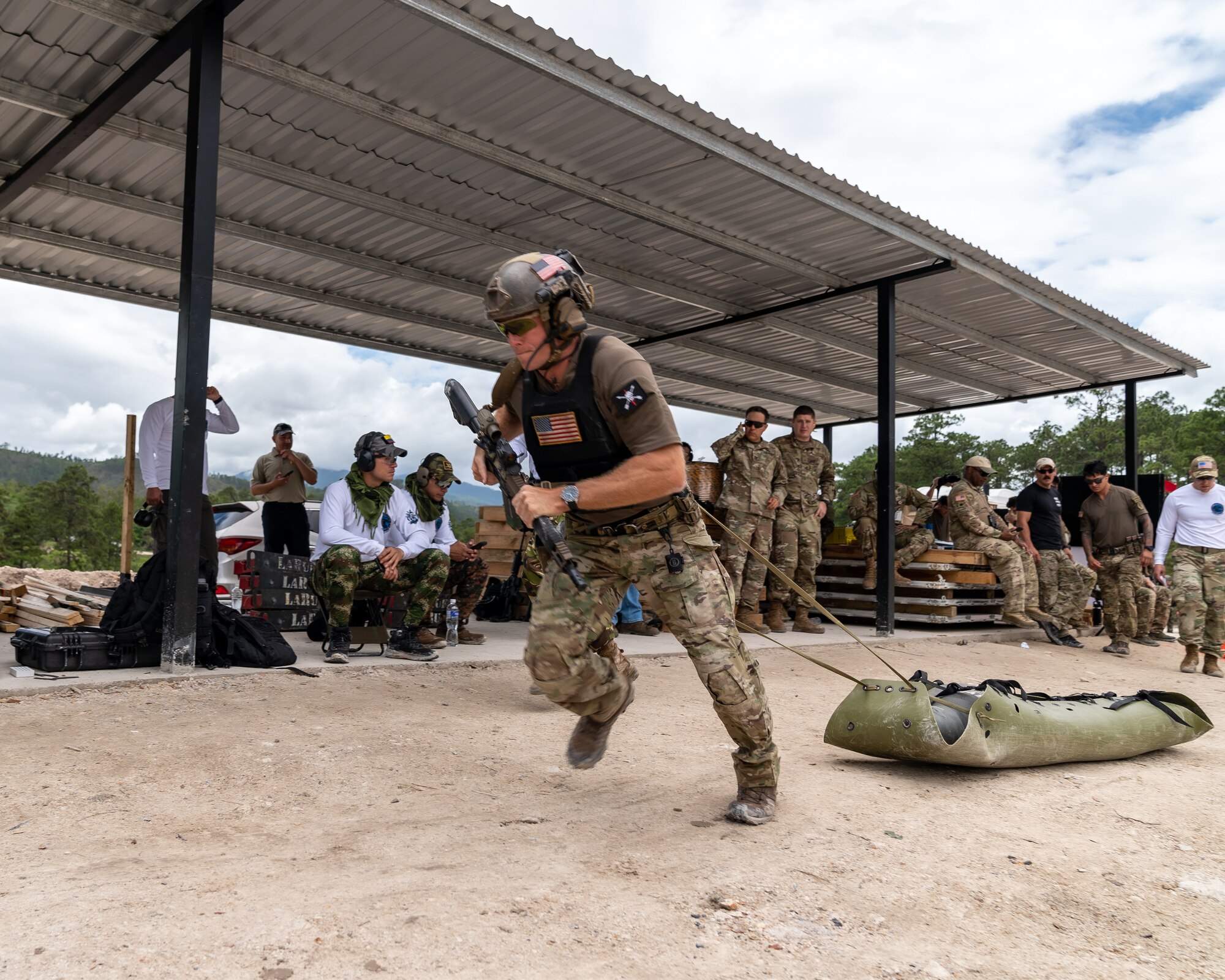 A United States team member pulls a sled as part of Fuerzas Comando 2022 Day 2 during an individual assault course in La Venta, Honduras, June 14, 2022. Fuerzas Comando is a Special Operation skills competition and a senior leader seminar supported by SOCSOUTH. The competition enhances SOF regional cooperation and exchanges best practices to combat transnational crime and counter illicit activities. (U.S. Air Force photo by Tech. Sgt. Lionel Castellano)