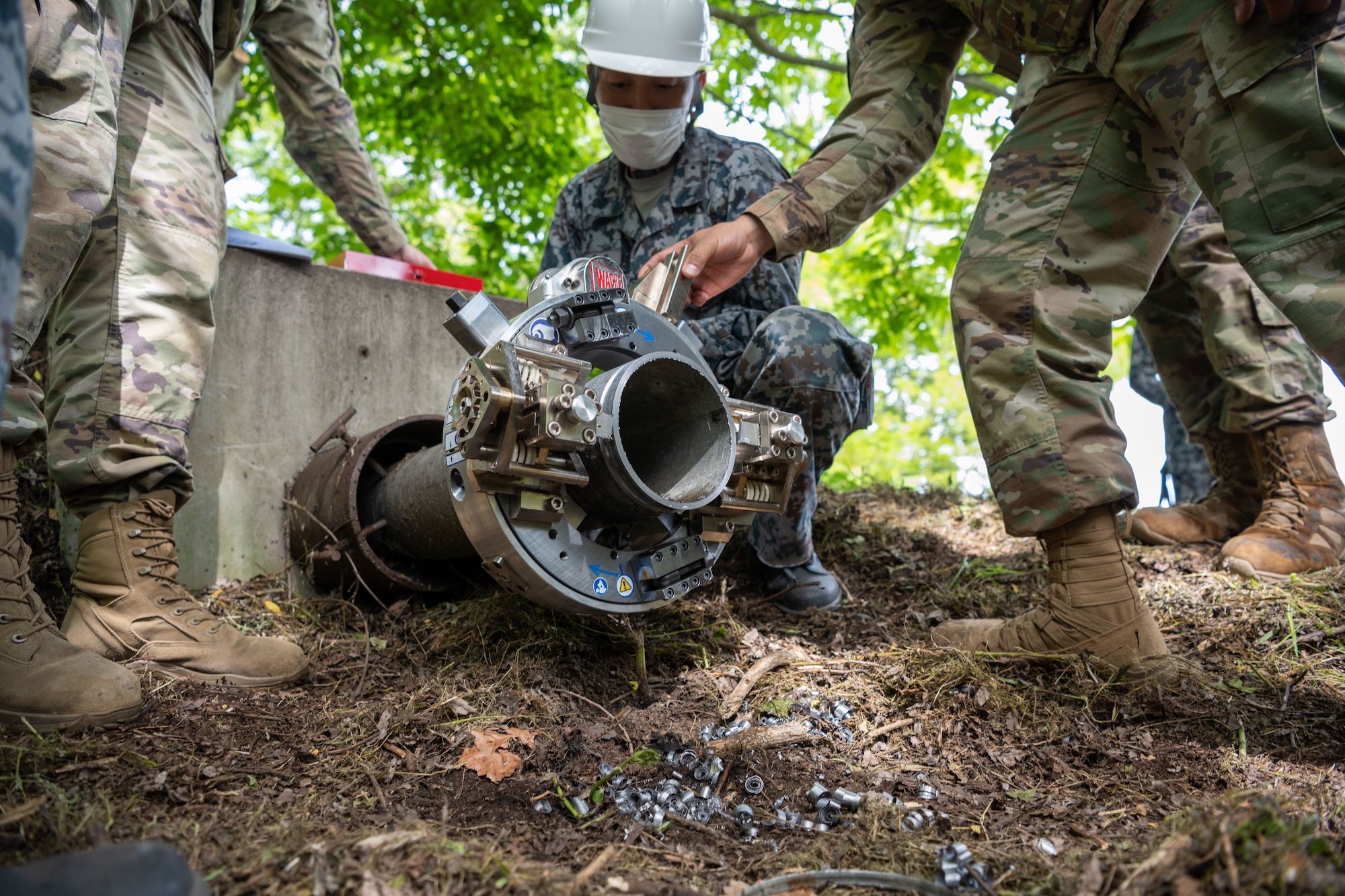 Japan Air Self-Defense Force Tech. Sgt. Akashi Kikuchi, 3rd Air Wing Civil Engineer Squadron water and fuel system maintainer, looks at new components on the Water and Fuel Expedient Repair System during the annual Prime Base Engineer Emergency Force training at Misawa Air Base, Japan, June 14, 2022.