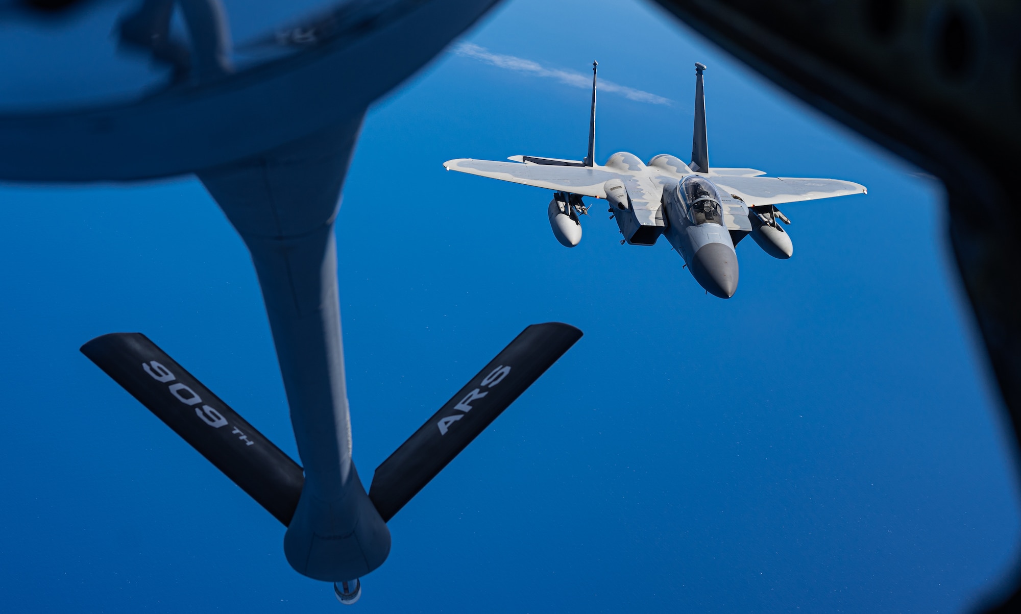 A plane flies over the ocean.