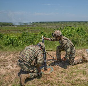 U.S. Army Georgia Army National Guard Spcs. Seth Fox, left, and Kwasi Fowler, indirect fire infantrymen assigned to A Company, 1st Battalion, 121st Infantry Regiment, 48th Infantry Brigade Combat Team, execute fire missions during the 48th IBCT's Exportable Combat Training Capability exercise at Fort Stewart, Ga, June 15, 2022. The exercise included approximately 4,400 brigade personnel from throughout Georgia.