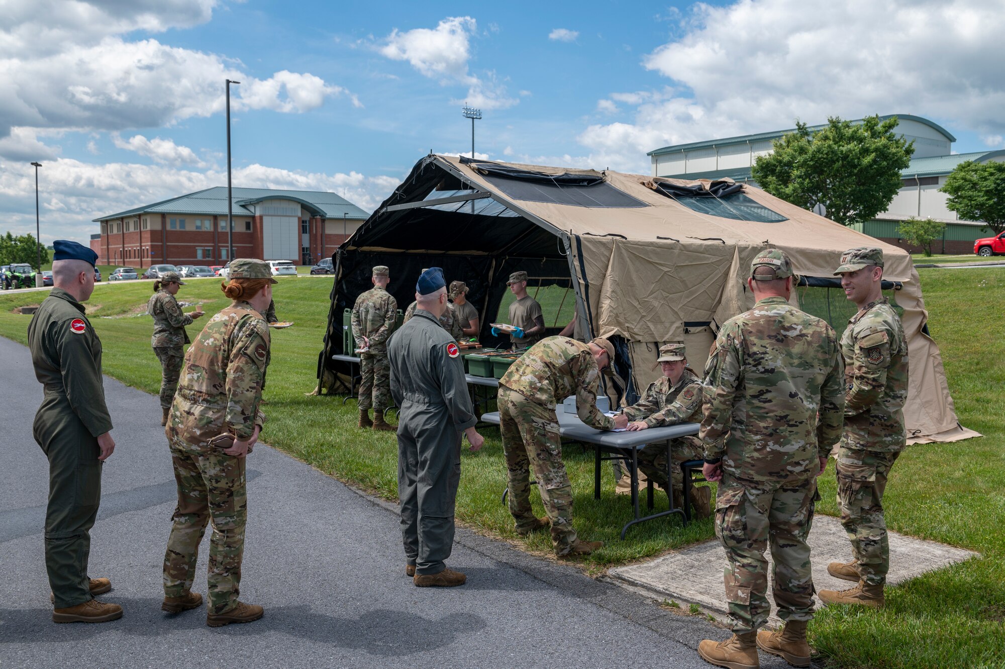 Airmen with the 167th Airlift Wing stand in line at a single pallet expeditionary kitchen (SPEK) as part of field feeding operations during June’s unit training assembly at the 167th Airlift Wing, Martinsburg, West Virginia, June 9, 2022. The purpose of the SPEK exercise is to provide valuable training to the 167th FSS Airmen while utilizing the mobile kitchen that can be operated in a deployed environment.