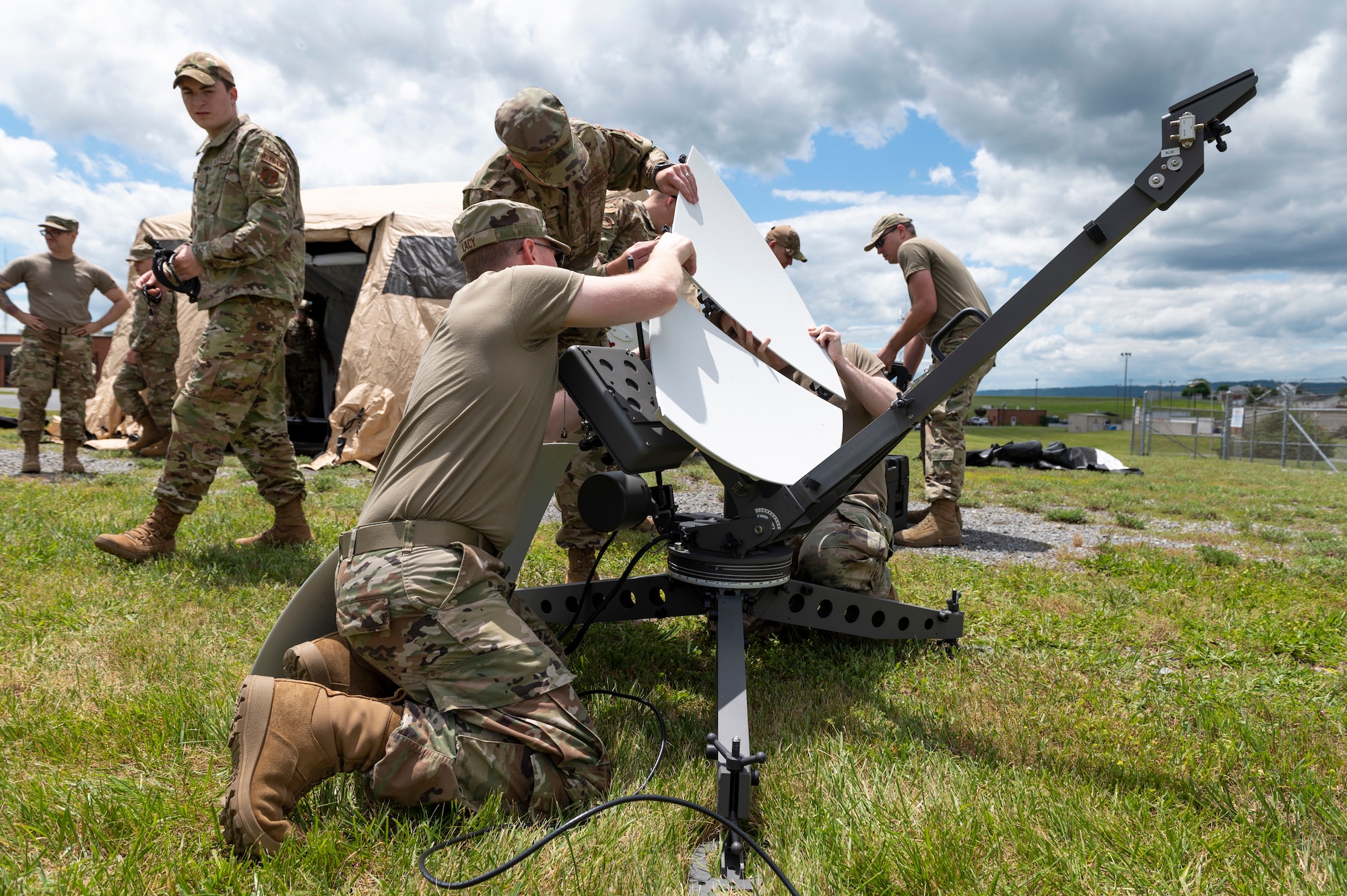 U.S. Air Force Tech. Sgt. Phillip Lacy and Master Sgt. Jacob Kent, cyber security specialists with the 167th Communications Squadron, disassemble a satellite component during a joint incident site communications capability (JISCC) training event at the 167th Airlift Wing, Martinsburg, West Virginia, June 9, 2022. The JISCC system allows communication between civilian and military partners in environments where communication assets are not available