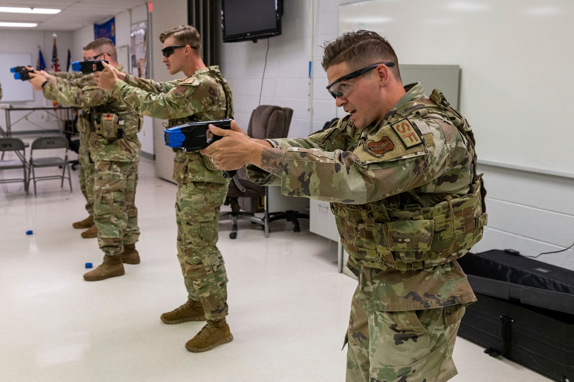 Defenders with the 167th Security Forces Squadron aim their tasers as part of a mock taser deployment training during June’s unit training assembly at the 167th Airlift Wing, Martinsburg, West Virginia, June 10, 2022. Trainings like these allow security forces personnel to become more familiar with their weapon platforms and practice using non-lethal force