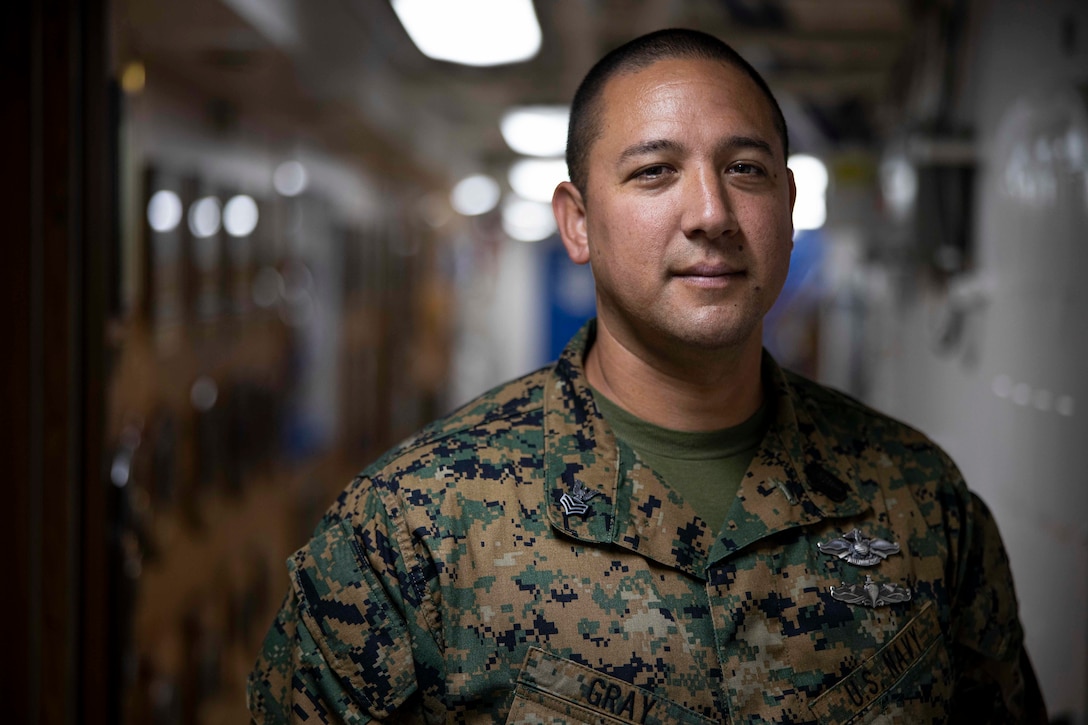 Hospital Corpsman 1st Class Gray is a preventive medicine technician at 2nd MEB. He manages medical readiness and advises senior staff on all matters of force health protection. Gray describes what it means to be a Navy Corpsman, “Being a Navy Corpsman means being compassionate, caring, a mentor, a guide, a brother or sister to Sailors and Marines. I like being with the Marines and taking care of them. They will always take care of you. It’s a special bond – Corpsman and Marine. It’s like a brotherhood.”