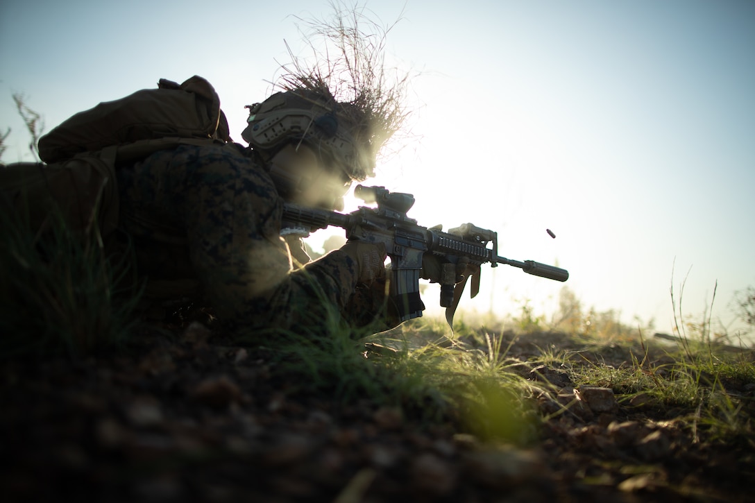 A U.S. Marine with India Company, 3rd Battalion, 7th Marine Regiment, Ground Combat Element, Marine Rotational Force-Darwin 22, fires his service weapon during a platoon live-fire attack as part of exercise Darrandarra 22, at Mount Bundey Training Area, NT, Australia, June 10, 2022. Exercise Darrandarra 22 increases MRF-D 22’s readiness to respond to realistic crises throughout the range of military operations within the region.