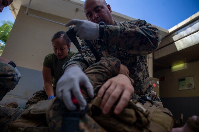U.S. Navy Hospital Corpsmen Armondo Zubri Jr. with Combat Logistics Battalion 15, Combat Logistics Regiment 17, 1st Marine Logistics Group, prepares a simulated casualty for movement during a Mass Casualty training event in support of Valiant Shield 2022 on Palau, June 4, 2022. Mass casualty drills test the corpsmen’s ability to treat and stabilize large numbers of casualties with various wounds.