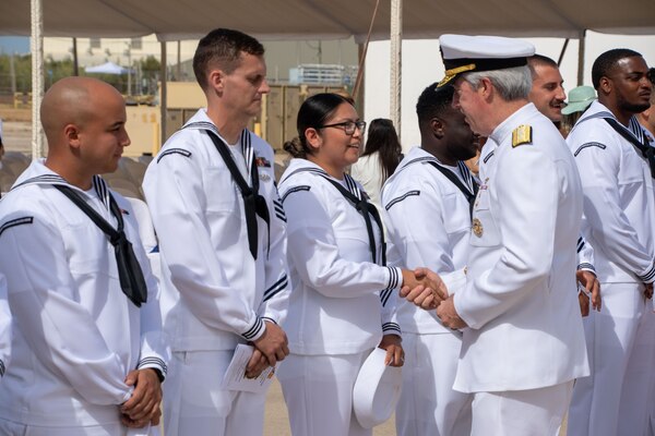 Adm. Meier shakes hand with sailor.