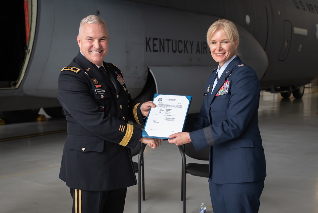 The adjutant general of the Kentucky National Guard, Army Maj. Gen. Haldane B. Lamberton, left, presents Mary S. Decker, chief of staff for Joint Force Headquarters — Air, Kentucky National Guard, with the order promoting her to the rank of brigadier general during a ceremony at the Kentucky Air National Guard Base in Louisville, Ky., June 11, 2022. Decker joined the Air Force in 1987 as an airman basic. (U.S. Air National Guard photo by Dale Greer)