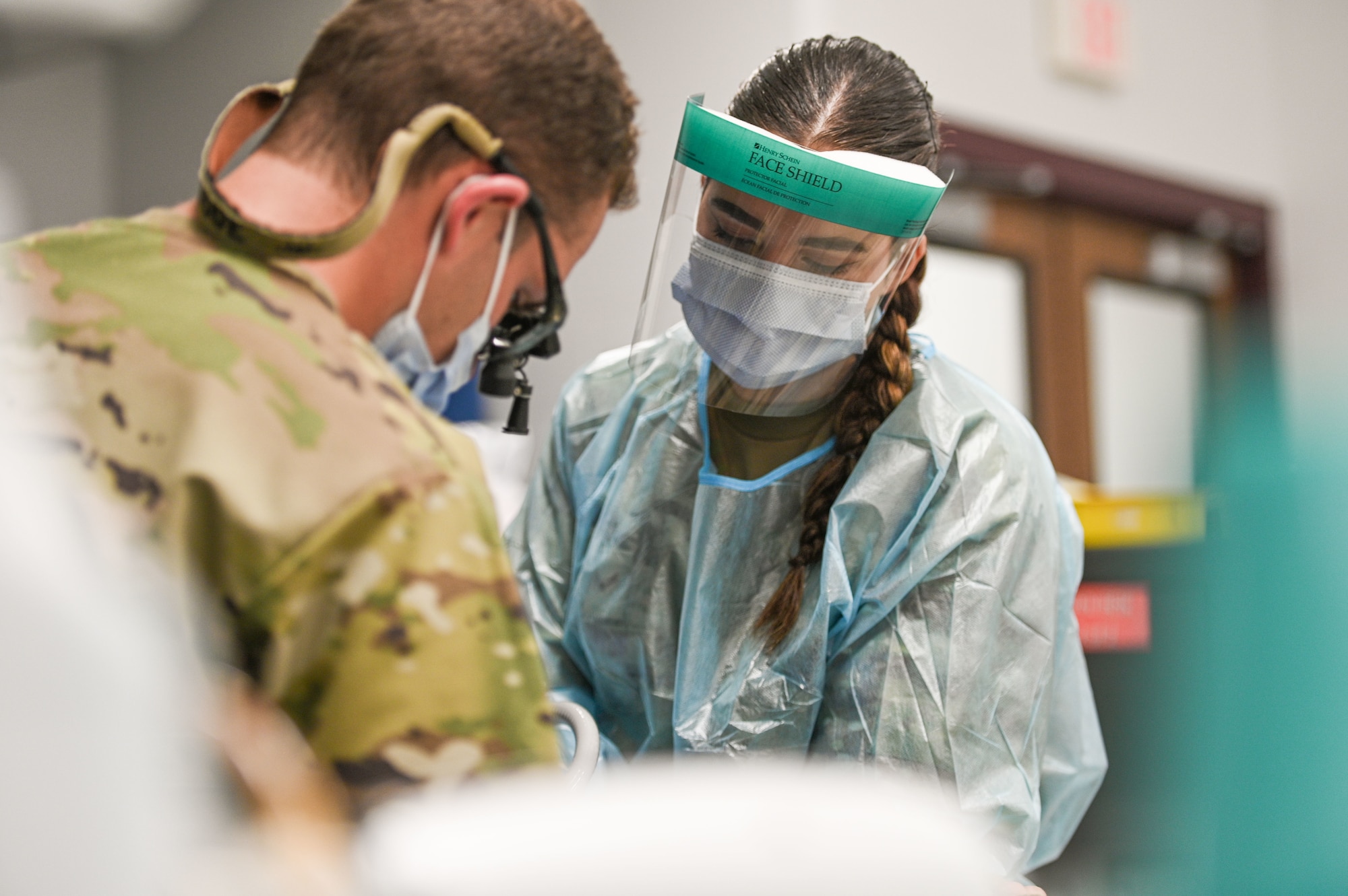Image of Airmen helping a patient.