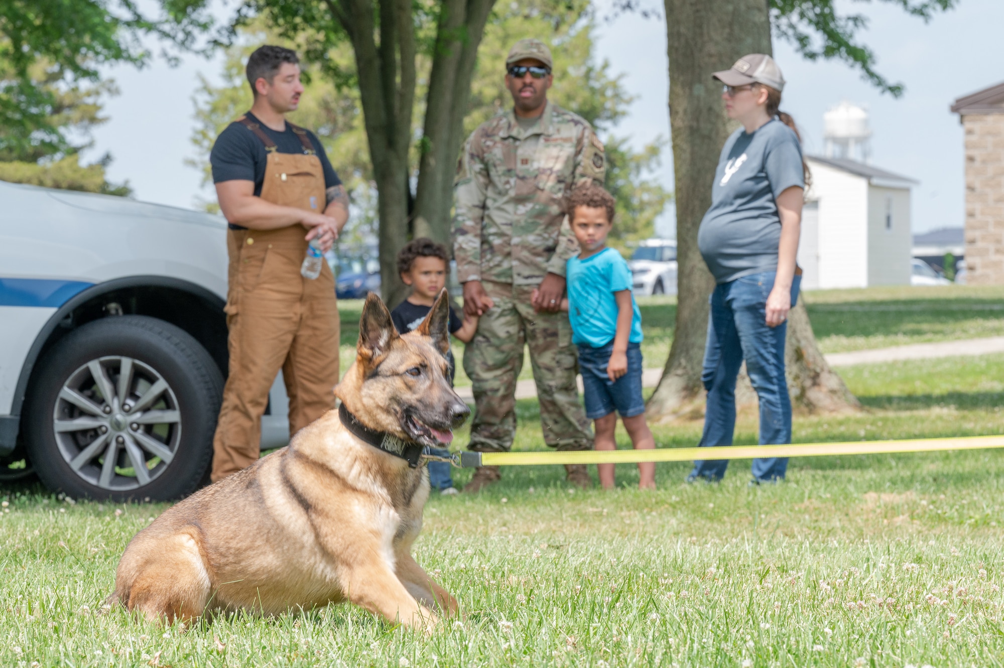 Participants of the 2022 Children’s Day Celebration observe military working dog training at Dover Air Force Base, Delaware, June 13, 2022. This year’s celebration offered outdoor activities and a mock deployment line to Team Dover families. (U.S. Air Force photo by Mauricio Campino)