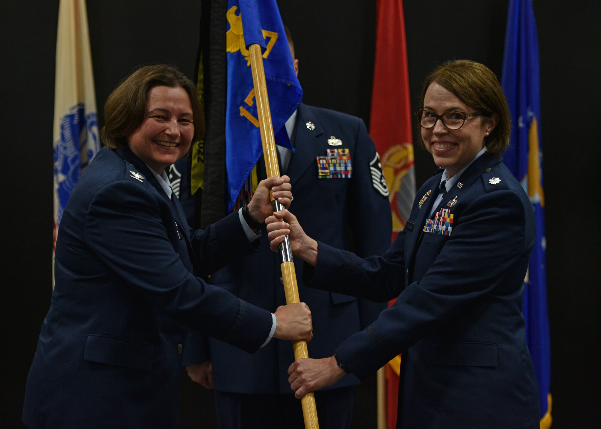 U.S. Air Force Lt. Col. Renee Fontenot, right, 17th Training Support Squadron incoming commander, assumes command from Col. Angelina Maguinness, 17th Training Group commander, during the 17th TRSS change of command ceremony at the Powell Event Center, Goodfellow Air Force Base, Texas, June 17, 2022. Change of commands are a military tradition representing the transfer of responsibilities from the outgoing commander to the incoming commander. (U.S. Air Force photo by Senior Airman Ashley Thrash)