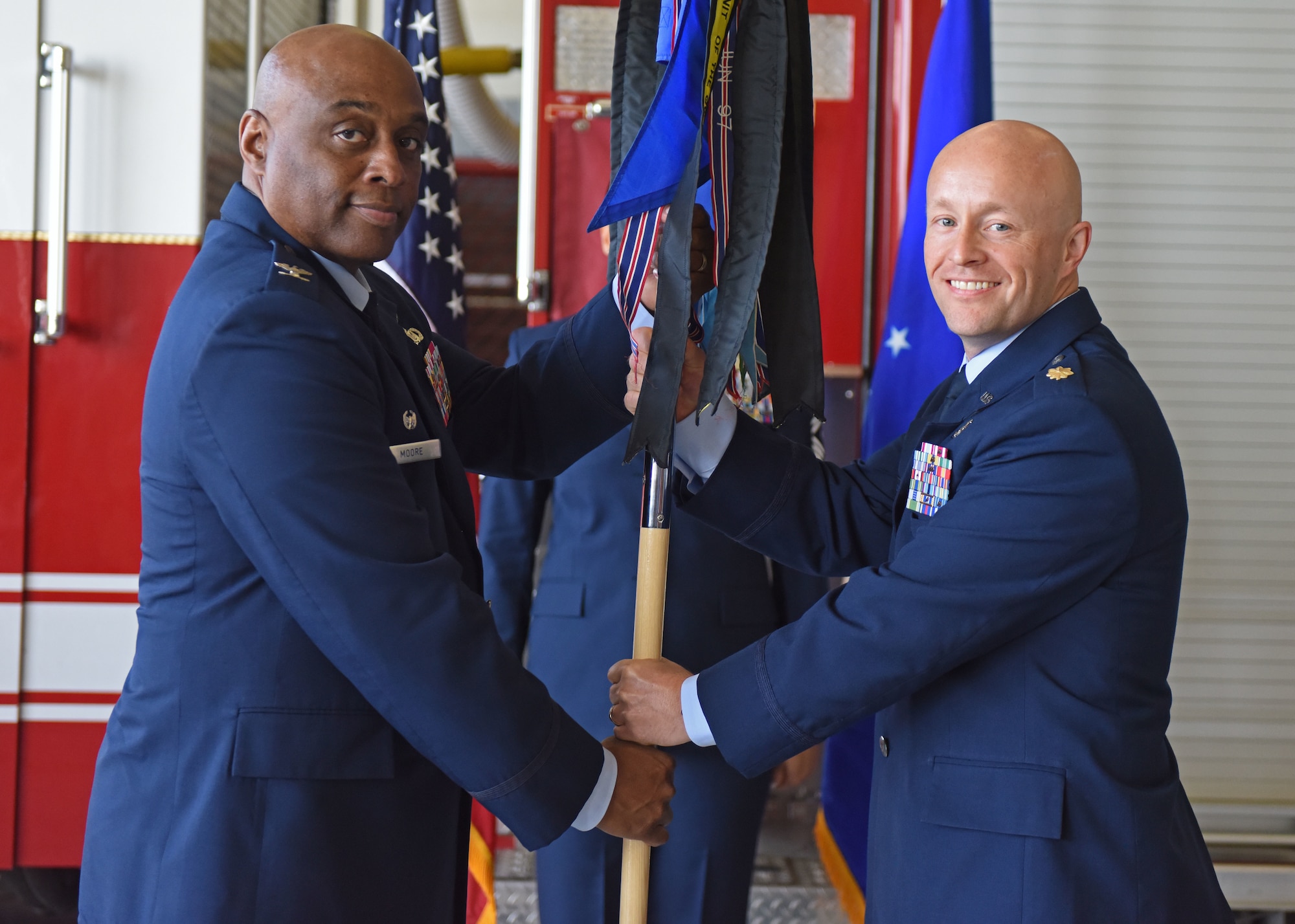 U.S. Air Force Maj. Joshua Carroll, right, 17th Civil Engineer Squadron incoming commander, assumes command from Col. Eugene Moore III, 17th Mission Support Group commander, during the 17th CES change of command ceremony at Goodfellow Air Force Base, Texas, June 17, 2022. Change of commands are a military tradition representing the transfer of responsibilities from the outgoing commander to the incoming commander. (U.S. Air Force photo by Airman 1st Class Sarah Williams)