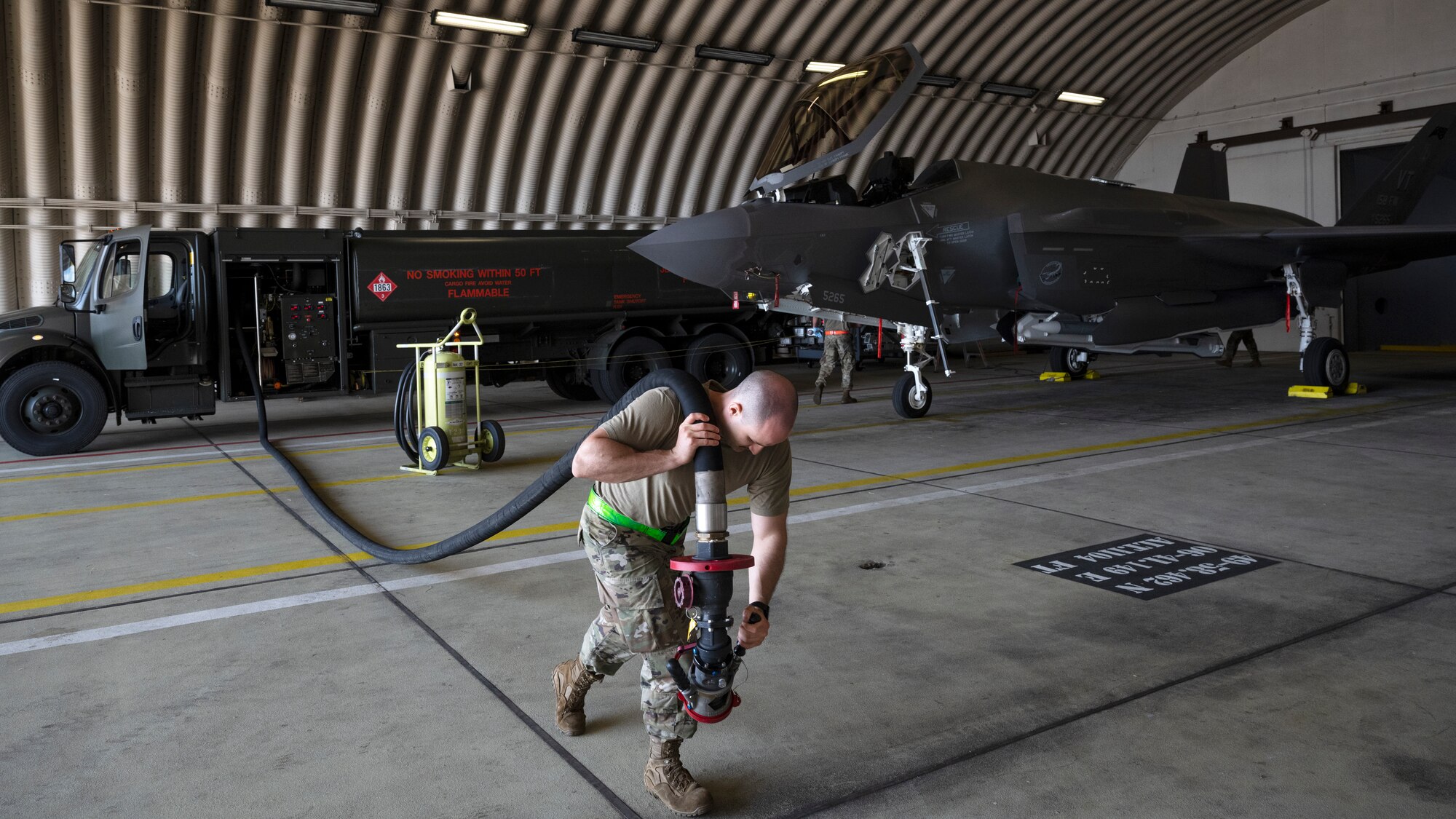 U.S. Air Force Staff Sgt. Devin Bonnett, 158th Fighter Wing, fuels distribution supervisor, unwinds the fuel hose from an R-11 truck prior to refueling an F-35A Lightning II aircraft at Spangdahlem Air Base, Germany, June 13, 2022. Airmen assigned to the Vermont Air National Guard are deployed to Europe to increase readiness and enhance NATO's collective defense. (U.S. Air Force photo by Tech. Sgt. Anthony Plyler)