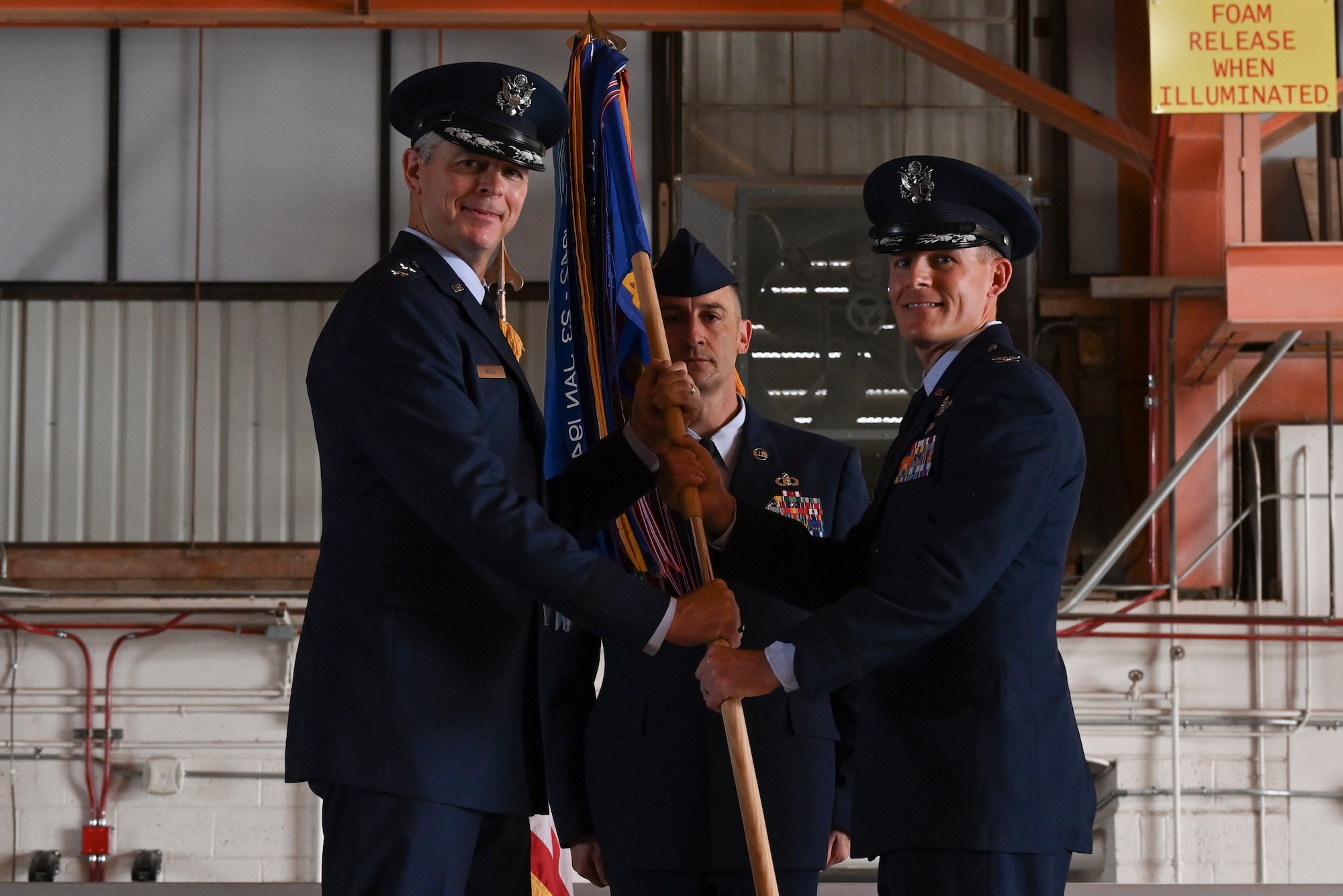 Col. Justin B. Spears accepts command of the 49th Wing from Maj. Gen. Craig D. Wills, 19th Air Force commander, during a change of command ceremony, June 17, 2022, on Holloman Air Force Base, New Mexico. Spears previously served as the commander of the 14th Operations Group at Columbus AFB, Mississippi, before assuming his new role at Holloman. (U.S. Air Force photo by Airman 1st Class Antonio Salfran)