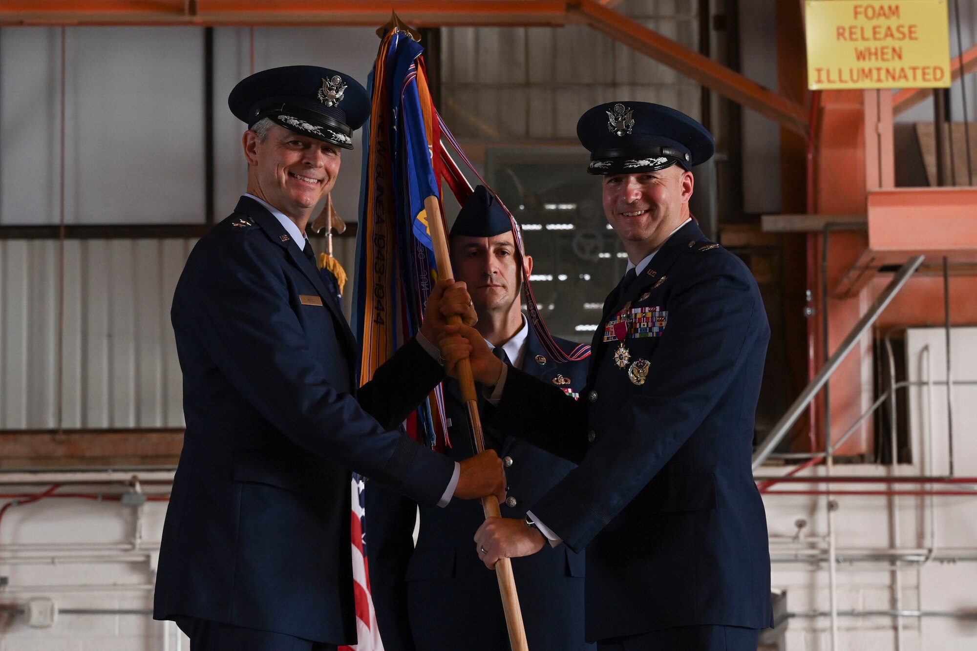 Col. Ryan P. Keeney relinquishes command of the 49th Wing to Maj. Gen. Craig D. Wills, 19th Air Force commander, during a change of command ceremony, June 17, 2022, on Holloman Air Force Base, New Mexico. Keeney ended his tenure as commander after two years of leading the Fightin’ 49ers of the 49th Wing. (U.S. Air Force photo by Airman 1st Class Antonio Salfran)