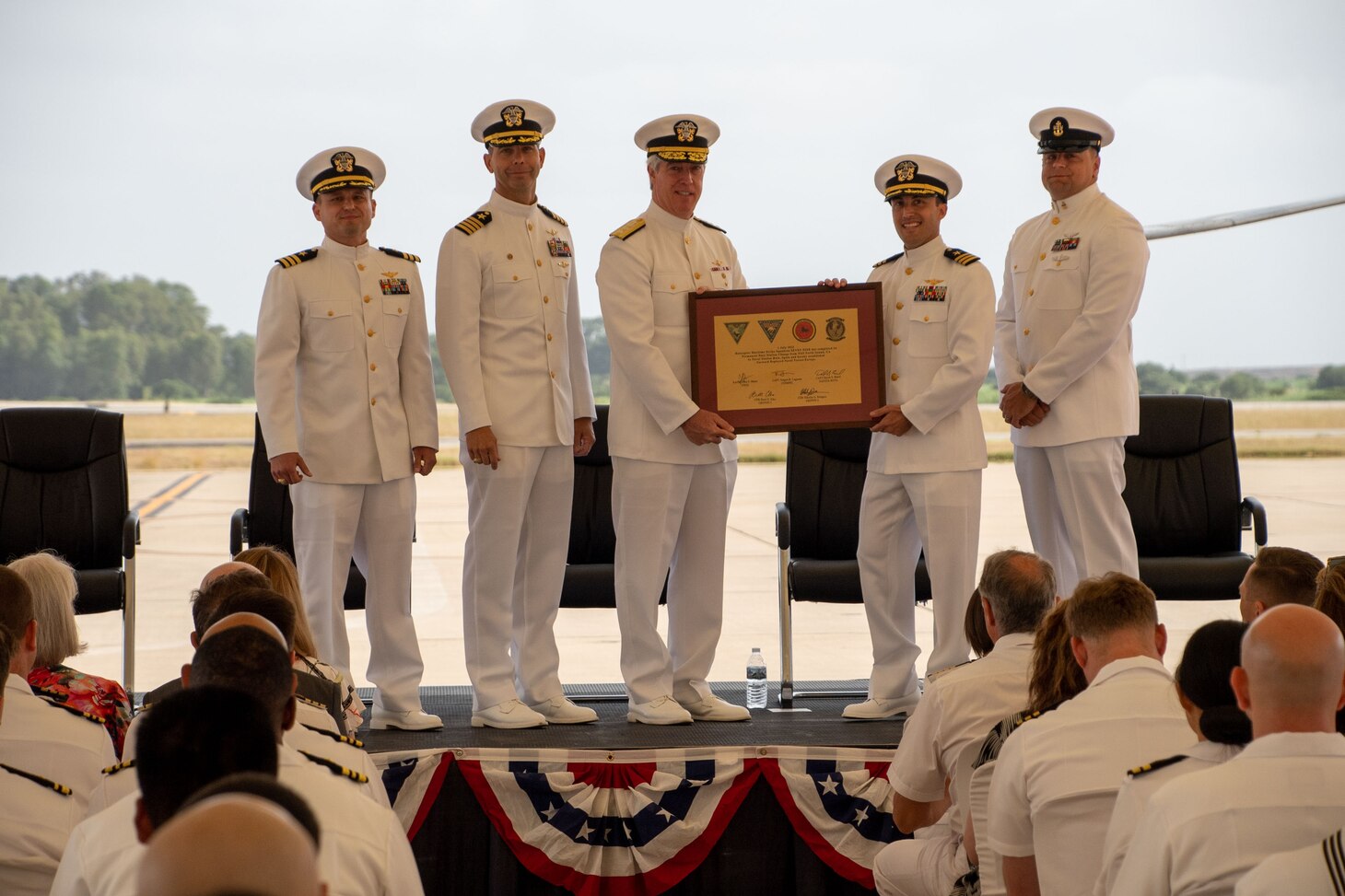 Sailors hold a plaque at the establishment ceremony for Helicopter Maritime Strike Squadron (HSM) 79 detachment, Rota, Spain.