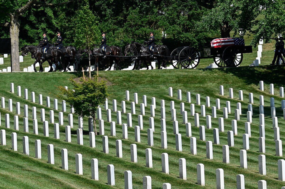 A funeral procession carries the casket of Air Force Brig. Gen. Charles E. McGee to his gravesite at Arlington National Cemetery, Arlington, Va., June 17, 2022. McGee, a Tuskegee Airman, died Jan. 16, 2022 at the age of 102. He served 30 years during World War II, the Korean War and the Vietnam War. (U.S. Air Force photo by Eric Dietrich)