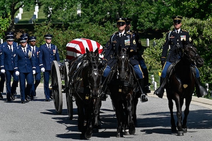 A funeral procession carries the casket of Air Force Brig. Gen. Charles E. McGee to his gravesite at Arlington National Cemetery, Arlington, Va., June 17, 2022. McGee, a Tuskegee Airman, died Jan. 16, 2022 at the age of 102. He served 30 years during World War II, the Korean War and the Vietnam War. (U.S. Air Force photo by Eric Dietrich)