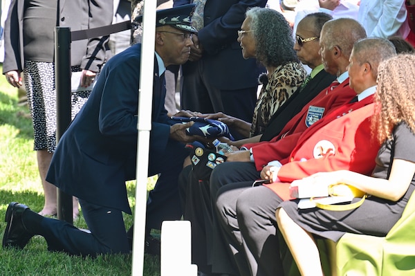 Air Force Chief of Staff Gen. CQ Brown, Jr. presents the American flag to Charlene McGee Smith, the daughter of Brig. Gen. Charles E. McGee, during his funeral at Arlington National Cemetery, Arlington, Va., June 17, 2022. McGee, a Tuskegee Airman, died Jan. 16, 2022 at the age of 102. He served 30 years during World War II, the Korean War and the Vietnam War. (U.S. Air Force photo by Eric Dietrich)
