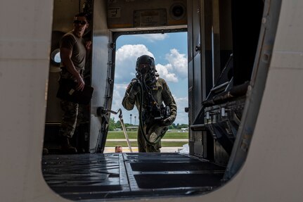 U.S. Air Force Captain Alex Kenney, a pilot with the 167th Airlift Squadron, boards a C-17 Globemaster III aircraft during a simulated chemical environment training at the 167th Airlift Wing, Martinsburg, West Virginia, June 10, 2022. This training included maintainers, loadmasters, pilots and other personnel to simulate the process of preparing, loading and flying the aircraft while in a hazardous chemical environment