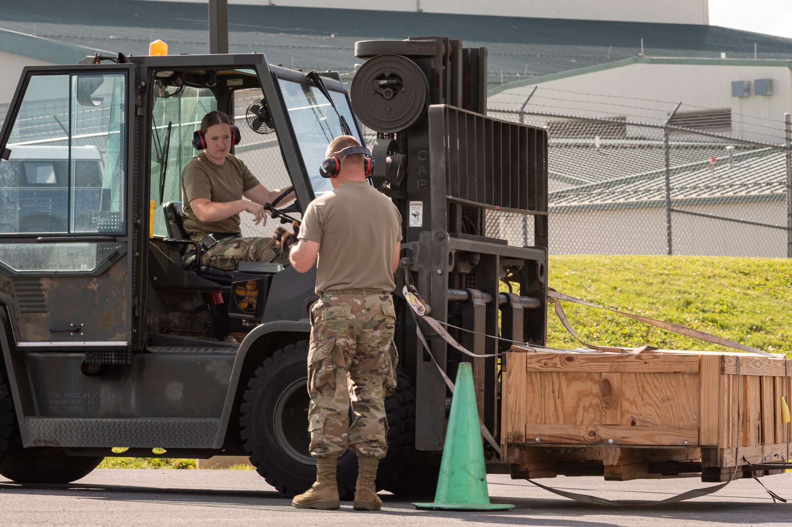 U.S. Air Force Master Sgt. Shad Jenkins, a ground transportation specialist with the 167th Logistics Readiness Squadron, instructs Senior Airman Haley Curry, traffic management specialist, as she drives a 10,000 pound forklift during a forklift certification event at the 167th Airlift Wing, Martinsburg, West Virginia, June 9, 2022. Airmen with the 167th LRS conduct forklift training such as this annually to ensure all their guardsmen are able to perform common heavy lifting tasks essential to the mission.