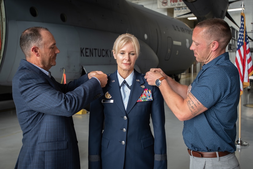 Family members pin brigadier general’s officer rank to the uniform of Mary S. Decker, chief of staff for Joint Force Headquarters — Air, Kentucky National Guard, during her promotion ceremony June 11, 2022 at the Kentucky Air National Guard Base in Louisville, Ky. Decker joined the Air Force in 1987 as an airman basic. (U.S. Air National Guard photo by Dale Greer)