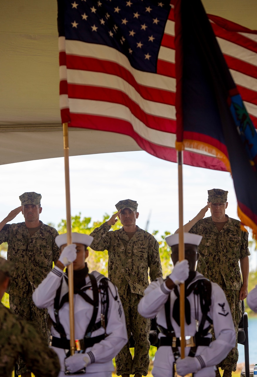 PITI, Guam (June 17, 2022) Vice Commander, U.S. 7th Fleet, Rear Adm. Robert Clark, right, and Capt. Shaun Lieb, center, salute during the Commander, Task Force 75 change of command ceremony. Capt. Gareth Healy relinquished command as Commodore, CTF 75 to Lieb. CTF 75 provides expeditionary combat capabilities in the U.S. Navy's 7th Fleet area of operations and is capable of providing the fleet with diverse expeditionary warfighting capabilities that are combat-ready and able to deploy anywhere in U.S. 7th Fleet in response to any contingency. The Navy's expeditionary forces exist first and foremost to support the fleet's warfighting operations and are the Navy's sea-to-shore interface. (U.S. Navy photo by Mass Communication Specialist 1st Class Billy Ho)