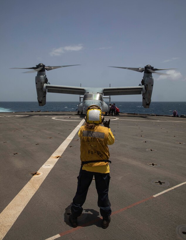 Boatswain’s Mate 2nd Class Amanda Bishop gives signals to the pilot in an MV-22B Osprey assigned to Marine Medium Tiltrotor Squadron (VMM) 266 on the flight deck of the Harpers Ferry-class dock landing ship USS Carter Hall (LSD 50), during exercise Caraibes 2022, June 13, 2022. Caraibes 2022 is a French led, combined and joint training exercise in the Caribbean involving naval, air and land assets. This multi-national exercise aims to promote cooperation among regional forces and their collective ability to successfully provide humanitarian assistance/disaster relief in response to a natural disaster.