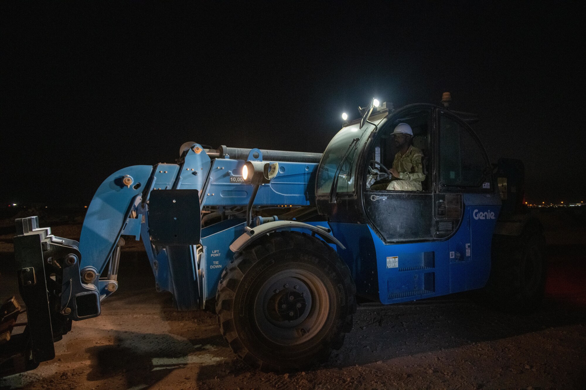 U.S. Air Force Tech. Sgt. Van Johnson, a structural journeyman with the 1st Expeditionary Civil Engineer Squadron, removes wooden pallets from a construction site on Al Udeid Air Base, Qatar, June 17, 2022. Organization is part of keeping the job site safe. (U.S. Air National Guard photo by Airman 1st Class Constantine Bambakidis)