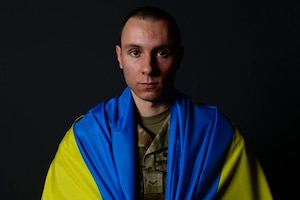 U.S Air Force Airman 1st Class Dmytro Rumiantsev, 82nd Comptroller Squadron financial management technician, from Sheppard Air Force Base, Texas, wears a Ukraine flag around his uniform