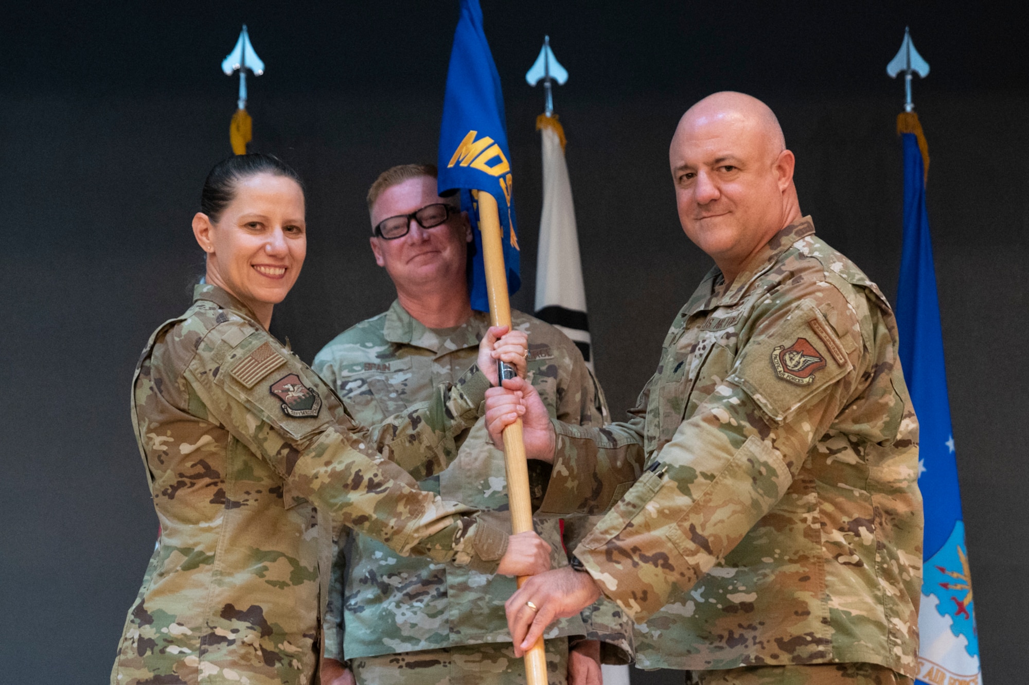 Col. Jennifer Vecchione, left, 51st Medical Group commander, presents the guidon to Lt. Col. Marc Rittberg, 51st Medical Support Squadron (MDSS) incoming commander