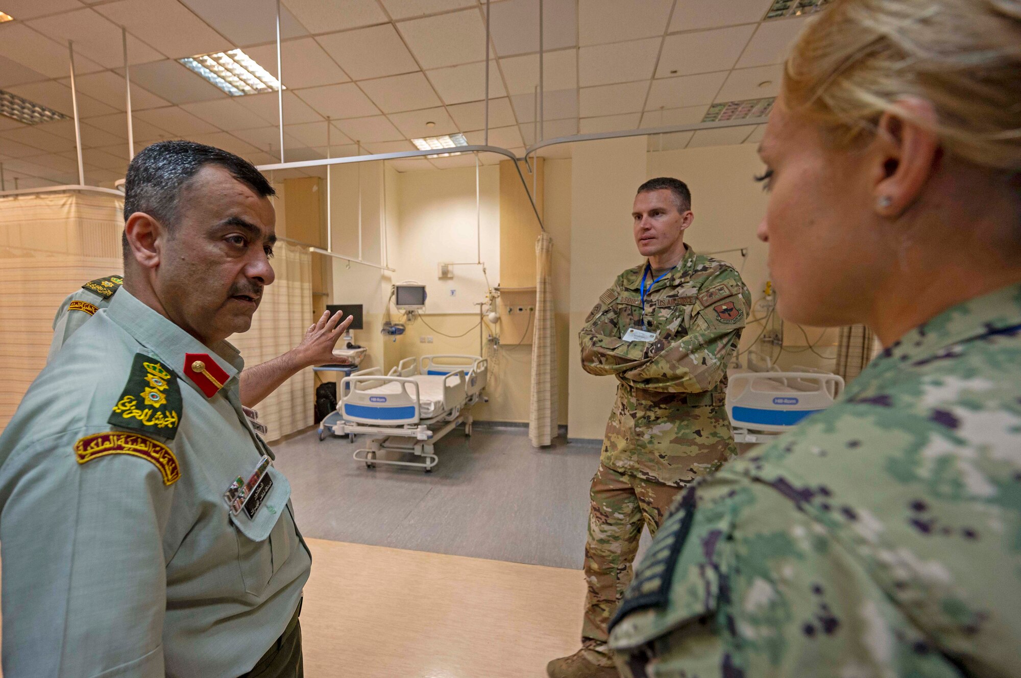 Dr. Abdula Mheerat, Jordanian Royal Medical Service Chief of emergency department, Jordanian Royal Medical Service, discusses post-surgery procedures and capabilities with Lt. Cmdr. Taylor DesRosiers, Walter Reed Medical Center critical care fellow, and Lt. Col. Erik DeSoucy, Brooke Army Medical Center trauma surgeon and critical care physician inside the King Hussein Medical Center May 8, 2022 in Amman, Jordan.