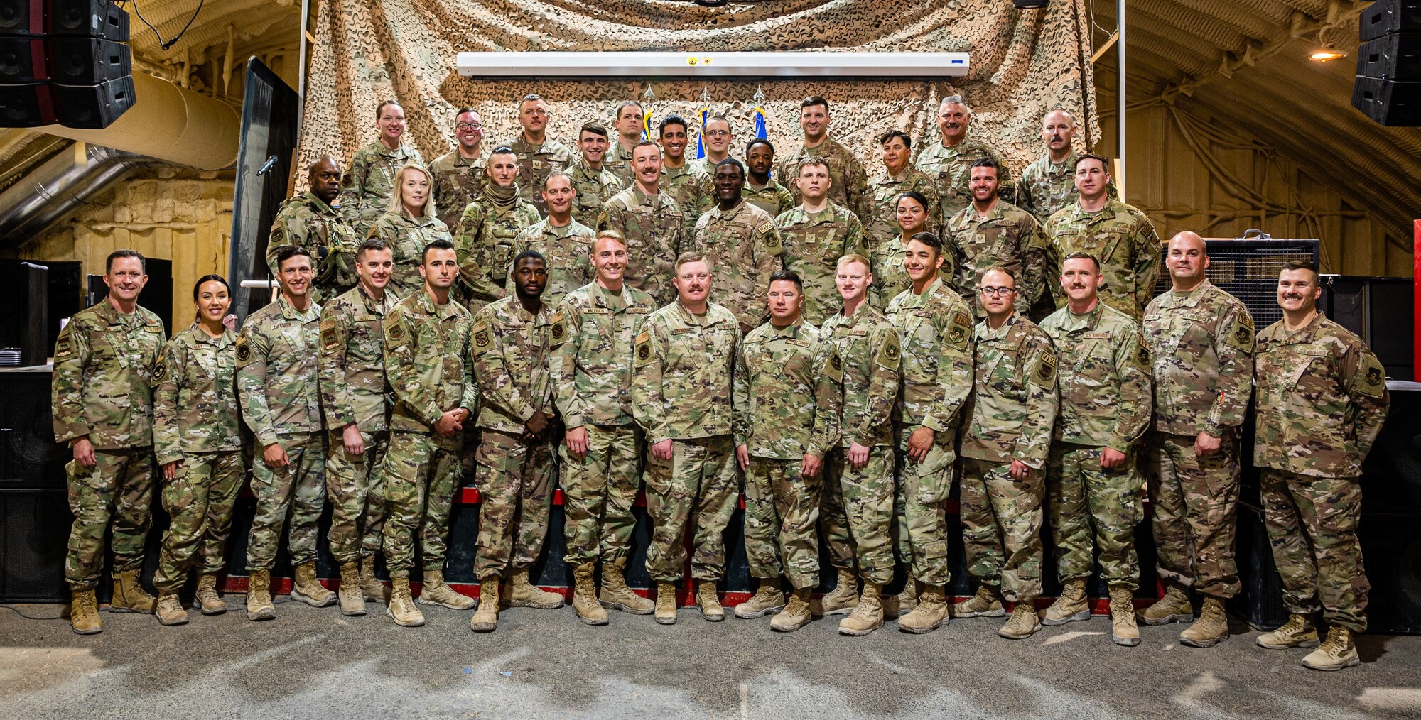 332d Air Expeditionary Wing leadership and Airpower Leadership Academy instructors pose alongside ALA graduates at an undisclosed location in Southwest Asia, June 18, 2022. ALA is a nine-week leadership program for select 332d Air Expeditionary Wing noncommissioned officers designed to cultivate future leaders. (U.S. Air Force photo by Master Sgt. Christopher Parr)