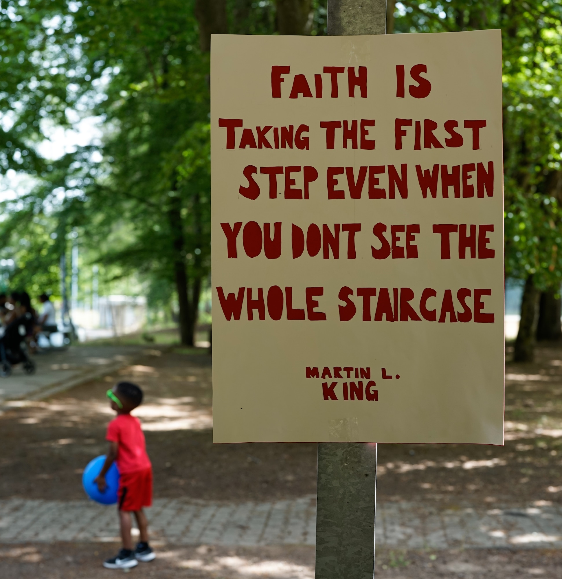 A poster with an inspirational quote hangs in the park at Pulaski Barracks, Germany, June 18, 2022. The poster was one of many inspirational quotes placed throughout the park in honor of the Juneteenth Celebration. (U.S. Air Force photo by Airman 1st Class Lauren Jacoby)