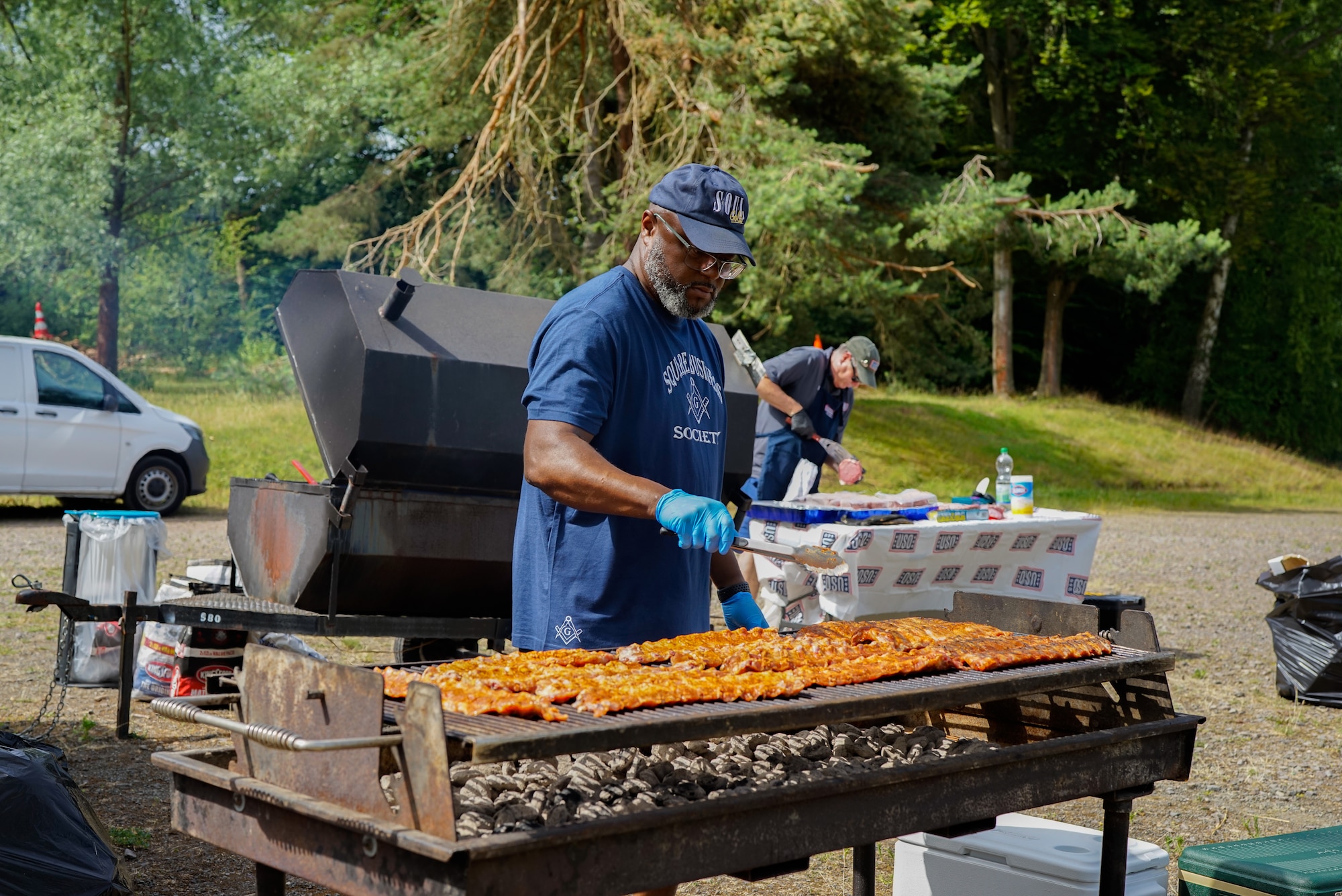 Volunteers prepare food at the Kaiserslautern Military Community’s second annual Juneteenth celebration at Pulaski Barracks, Germany, June 18, 2022. The event was hosted by the African-American Heritage Committee and included a kid zone, dominoes tournament and educational speakers. (U.S. Air Force photo by Airman 1st Class Lauren Jacoby)