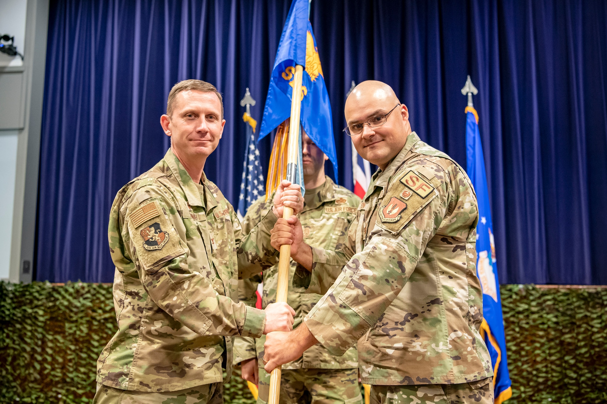 U.S. Air Force Maj. Kendall P. Benton, right, 422d Security Forces Squadron incoming commander, receives the 422d SFS guidon from Col. Jon T. Hannah, 422d Air Base Group commander, during a change of command ceremony at RAF Croughton, England, June 16, 2022. Prior to assuming command of the 422d SFS, Benton served as the Action Officer for the Policy Branch in the Air Force Security Forces Directorate at the Pentagon in Washington, D.C. (U.S. Air Force photo by Staff Sgt. Eugene Oliver)