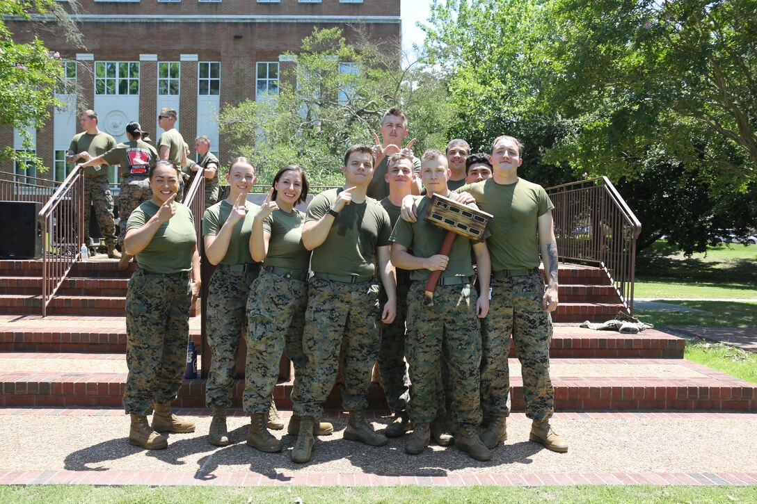 U.S. Marines with Plans, Policies and Operations, South, hold up a trophy earned while attending a command field meet, Naval Support Activity Hampton Roads, Norfolk, Virginia, June 10, 2022. FMFLANT, MARFORCOM, MARFOR NORTHCOM holds regular field meets to sustain camaraderie and healthy work relations. (U.S. Marine Corps photo by Sgt. Kealii De Los Santos)