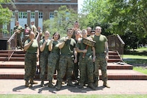 U.S. Marines with Plans, Policies and Operations, South, hold up a trophy earned while attending a command field meet, Naval Support Activity Hampton Roads, Norfolk, Virginia, June 10, 2022. FMFLANT, MARFORCOM, MARFOR NORTHCOM holds regular field meets to sustain camaraderie and healthy work relations. (U.S. Marine Corps photo by Sgt. Kealii De Los Santos)